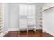 Walk-in closet features hardwood floors, built-in shelves, drawers and hanging space at 90021 Hoey, Chapel Hill, NC 27517