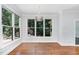 Light-filled dining area features hardwood flooring, large windows, and stylish light fixture at 90021 Hoey, Chapel Hill, NC 27517