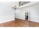 Formal dining room with chandelier, hardwood floors and trim, and adjacent rooms at 90021 Hoey, Chapel Hill, NC 27517