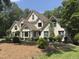 Charming two-story home with mature landscaping, arched windows, and a well-maintained lawn at 90021 Hoey, Chapel Hill, NC 27517