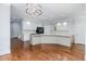 Spacious white kitchen with stylish lighting, modern countertops, and sleek appliances at 90021 Hoey, Chapel Hill, NC 27517