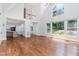 Spacious open living room leading to the kitchen, featuring hardwood floors and large windows at 90021 Hoey, Chapel Hill, NC 27517