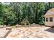 Outdoor patio with a built-in grill and stone countertops, perfect for outdoor entertaining and summer barbecues at 90021 Hoey, Chapel Hill, NC 27517