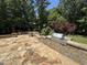 Outdoor kitchen with built-in grill, stone countertops, and elegant stone patio for entertaining at 90021 Hoey, Chapel Hill, NC 27517