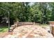 Stone patio seating area offers a relaxing spot to enjoy the outdoors in a beautifully landscaped setting at 90021 Hoey, Chapel Hill, NC 27517