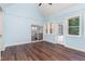 Sunroom with wood flooring, multiple windows, and views of the kitchen at 90021 Hoey, Chapel Hill, NC 27517