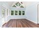 Bright sunroom with vaulted ceiling, multiple windows, and hardwood floors at 90021 Hoey, Chapel Hill, NC 27517