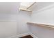 A bright walk-in closet provides ample storage with built in shelves and hanging rods at 90021 Hoey, Chapel Hill, NC 27517