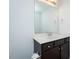 Well-lit bathroom featuring a single sink vanity, a large mirror, and neutral finishes at 905 Alice Ct, Haw River, NC 27258