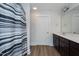 Bathroom features a modern vanity with dark cabinets and a white countertop, plus a shower with a striped curtain at 905 Alice Ct, Haw River, NC 27258