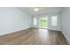 Spacious bedroom featuring hardwood flooring and a sliding glass door to the backyard at 905 Alice Ct, Haw River, NC 27258