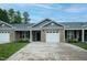 Attractive exterior showcasing a well-designed townhome with a charming entrance and a one-car garage at 905 Alice Ct, Haw River, NC 27258