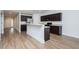 The modern kitchen opens to other rooms, boasting sleek appliances and counter seating at 905 Alice Ct, Haw River, NC 27258