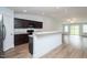 Open-concept kitchen with sleek countertops, stainless steel appliances, and an eat-in bar at 905 Alice Ct, Haw River, NC 27258