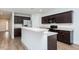 Stylish kitchen features dark cabinets, a breakfast bar, and stainless steel appliances at 905 Alice Ct, Haw River, NC 27258