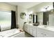A luxurious bathroom features a soaking tub, double vanity, and elegant fixtures for relaxation and convenience at 9123 Thomas Rd, Rocky Mount, NC 27803