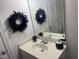 Bathroom vanity featuring a white countertop, stylish black and white vases and feather decor at 9123 Thomas Rd, Rocky Mount, NC 27803
