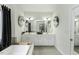 A bright bathroom featuring a soaking tub, double vanity, and tiled accents to add elegance and functionality at 9123 Thomas Rd, Rocky Mount, NC 27803