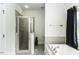 A well-lit bathroom featuring a glass-enclosed shower, a soaking tub, and tiled accents at 9123 Thomas Rd, Rocky Mount, NC 27803