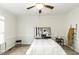 A serene bedroom features soft carpet, a ceiling fan, and ample natural light for a peaceful ambiance at 9123 Thomas Rd, Rocky Mount, NC 27803