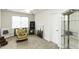 A lovely bedroom with a ceiling fan, chair, carpeted floors, and modern artwork at 9123 Thomas Rd, Rocky Mount, NC 27803