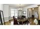Elegant dining room boasts natural light, hardwood floors and decorative chandelier at 9123 Thomas Rd, Rocky Mount, NC 27803