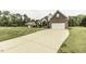 View of home with long driveway and detached garage at 9123 Thomas Rd, Rocky Mount, NC 27803