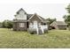 Brick house with staircase, white trim, and grass lawn at 9123 Thomas Rd, Rocky Mount, NC 27803