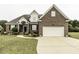 Charming brick home with an attached garage and a curved walkway to the front door at 9123 Thomas Rd, Rocky Mount, NC 27803