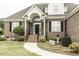 Charming front entrance with manicured landscaping and a brick facade at 9123 Thomas Rd, Rocky Mount, NC 27803