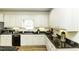 Updated kitchen featuring black appliances, and granite countertops and custom cabinets at 9123 Thomas Rd, Rocky Mount, NC 27803