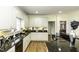 Bright and airy kitchen featuring granite countertops, white cabinetry, and hardwood floors at 9123 Thomas Rd, Rocky Mount, NC 27803