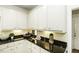 Elegant kitchen with granite countertops, white cabinets, and modern lighting at 9123 Thomas Rd, Rocky Mount, NC 27803