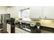 Well-lit kitchen featuring stainless steel appliances, a double sink, and granite countertops at 9123 Thomas Rd, Rocky Mount, NC 27803