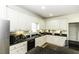 This kitchen features white cabinets, granite countertops, and modern appliances, blending style and functionality at 9123 Thomas Rd, Rocky Mount, NC 27803