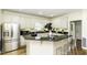 Bright kitchen features stainless steel appliances, white cabinetry, and a peninsula with bar seating at 9123 Thomas Rd, Rocky Mount, NC 27803