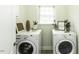 A bright laundry room features modern appliances, decor, and a window for ventilation and natural light at 9123 Thomas Rd, Rocky Mount, NC 27803