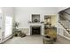 Inviting living area with fireplace, view to the kitchen, and staircase access at 9123 Thomas Rd, Rocky Mount, NC 27803