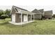 Outbuilding featuring brick construction, white doors and trim with a spacious grassy yard at 9123 Thomas Rd, Rocky Mount, NC 27803