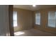 Bedroom featuring three windows, neutral carpet and ample space at 919 Middle Ground Ave, Rolesville, NC 27571