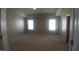 Large bedroom with tray ceiling, neutral carpet and two bright windows at 919 Middle Ground Ave, Rolesville, NC 27571