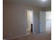 Bedroom view with carpet, doors, and a glimpse into a bathroom at 919 Middle Ground Ave, Rolesville, NC 27571