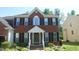 Traditional two-story brick home featuring black shutters and a welcoming front entrance at 919 Middle Ground Ave, Rolesville, NC 27571