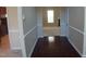 A view of the foyer featuring wood floors leading into a carpeted living area at 919 Middle Ground Ave, Rolesville, NC 27571