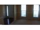 A carpeted room featuring a pair of large windows allowing natural light at 919 Middle Ground Ave, Rolesville, NC 27571