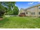 Well maintained backyard with green grass, deck and trees at 9639 Clubvalley Way, Raleigh, NC 27617