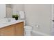 Bathroom with tan cabinets, white sink, toilet, shower and neutral wall color at 9639 Clubvalley Way, Raleigh, NC 27617