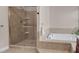 A tiled shower stall and a drop-in style garden tub are in this primary bathroom at 9639 Clubvalley Way, Raleigh, NC 27617