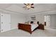 A nicely decorated bedroom features a ceiling fan, tray ceiling, and a queen-sized sleigh bed at 9639 Clubvalley Way, Raleigh, NC 27617