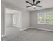 Bedroom featuring gray walls, plush carpet, and bright windows offering lots of natural light at 9639 Clubvalley Way, Raleigh, NC 27617